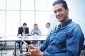 Businessman using digital tablet against colleagues in meeting room Royalty Free Stock Photo