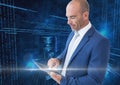 Businessman using digital tablet with binary codes against blue background