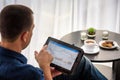 Businessman using digital tablet and drinking coffee. Smartphone Paper Cup Shirt Beard. Office Coffee Break Concept