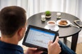 Businessman using digital tablet and drinking coffee. Smartphone Paper Cup Shirt Beard. Office Coffee Break Concept