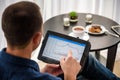 Businessman using digital tablet and drinking coffee. Smartphone Paper Cup Shirt Beard. Office Coffee Break Concept