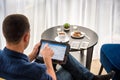 Businessman using digital tablet and drinking coffee. Smartphone Paper Cup Shirt Beard. Office Coffee Break Concept