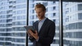 Businessman using digital tablet in office.Professional reading good news on pad Royalty Free Stock Photo