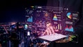 Businessman Using Digital Tablet to Display Data Visualization and Analytics with City Skyline at Night in Background Royalty Free Stock Photo