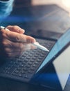 Businessman using electronic tablet keyboard-dock station at office. Closeup male hand pointing on device screen Royalty Free Stock Photo