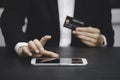 The businessman is using a hand typing keyboard and uses a modern credit card by laptop or smartphone Royalty Free Stock Photo