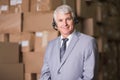 Businessman using headset in warehouse Royalty Free Stock Photo