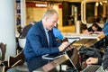 Businessman using his tablet at the airport Royalty Free Stock Photo