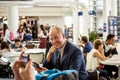 Businessman using his tablet at the airport Royalty Free Stock Photo