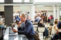 Businessman using his tablet at the airport Royalty Free Stock Photo