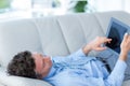 Businessman using his tablet on couch Royalty Free Stock Photo