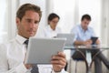 Businessman using his tablet in the office Royalty Free Stock Photo