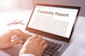 Man Typing Feasibility Report On Laptop Royalty Free Stock Photo