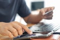 Businessman using laptop computer with a credit card making an online order. Royalty Free Stock Photo