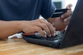 Businessman using laptop computer with a credit card making an online order Royalty Free Stock Photo