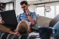 Man working on laptop computer while sitting on sofa Royalty Free Stock Photo