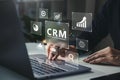 Businessman using laptop with CRM icon on virtual screen Royalty Free Stock Photo