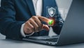 Businessman using a laptop with digital security and safety features shown Royalty Free Stock Photo
