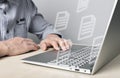 Businessman using laptop for electronic documents, letters sending and receiving. Man sitting at desk with computer Royalty Free Stock Photo