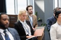 Businessman using laptop near interracial colleagues Royalty Free Stock Photo