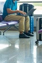 Businessman using laptop while sitting at waiting chair in airport Royalty Free Stock Photo