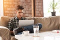 Businessman using laptop on sofa in coffee shop Royalty Free Stock Photo