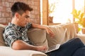 Businessman using laptop on sofa in coffee shop Royalty Free Stock Photo