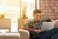 Businessman using laptop on sofa in coffee shop Royalty Free Stock Photo