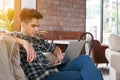 Businessman using laptop on sofa in coffee shop Royalty Free Stock Photo