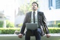 Businessman using laptop wit sitting in a bench and relaxing in Royalty Free Stock Photo