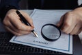 Businessman using magnifying glass to sign a contract Royalty Free Stock Photo