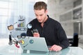 Businessman using magnifying lens and laptop for market analysis Royalty Free Stock Photo