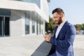 Businessman using mobile phone app outside at office Royalty Free Stock Photo