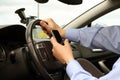 Businessman using mobile phone while driving the car Royalty Free Stock Photo