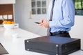 Businessman using mobile phone while standing by table Royalty Free Stock Photo