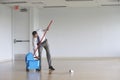 Businessman Using Mop In Empty Room Royalty Free Stock Photo