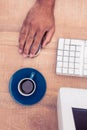 Businessman using mouse by coffee cup while working Royalty Free Stock Photo