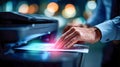 Businessman using a multifunction laser printer at night, tapping on the touchscreen panel in an office environment Royalty Free Stock Photo