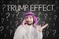 Businessman using a phone with Trump Effect word