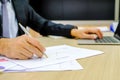 Businessman using red pen writing in notepad on office Royalty Free Stock Photo