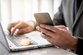 Businessman using samrtphone with golden bitcoin Royalty Free Stock Photo