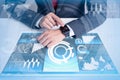 The businessman using a smart device and overlay with futuristic hologram. the concept of technology, applications, smart devices