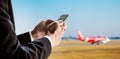 Businessman using smart phone with airplane background, concept of online checking in, mobile on plane and etc.