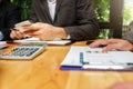 Businessman using smart phone while conference. Businessmen discussing together in meeting room. Business team meeting and Royalty Free Stock Photo