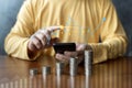 Businessman using smart phone mobile with business graph and stacking coins. Financial and Business growth, Economic Trends Royalty Free Stock Photo