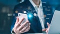 Businessman using smartphone with AI chatbot and multilingual translation icons, representing artificial intelligence, digital Royalty Free Stock Photo