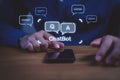 Businessman using smartphone with chatbot Q and A icons, representing AI communication, virtual assistant technology Royalty Free Stock Photo