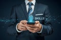 Businessman using smartphone for skills development with brain icon and network connection concept Royalty Free Stock Photo