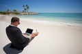 Businessman using tablet computer on the beach Royalty Free Stock Photo