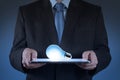 Businessman using tablet computer growing light bulb Royalty Free Stock Photo